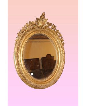 French oval mirror, Louis XV style, from the 1800s, gilded with gold leaf.