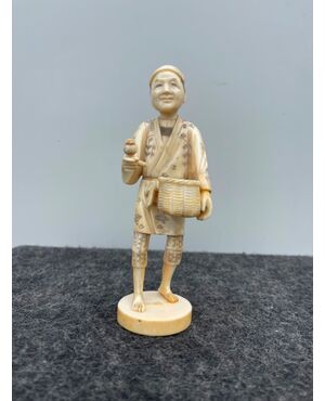 Okimono depicting a farmer with basket and pipe. Japan     