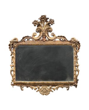 Carved and gilded wooden mirror. Italy, 18th century.