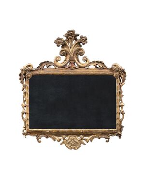 Carved and gilded wooden mirror. Italy, 18th century.