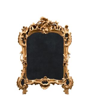 Carved and gilded wooden mirror. Venice, 18th century.
