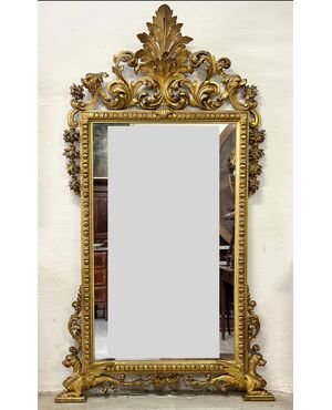 Carved and gilded wooden mirror. Tuscany, early 19th century.