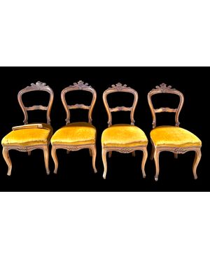 Four walnut chairs carved with rocaille motifs.