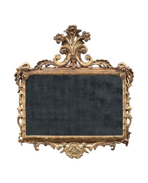 Carved and gilded wooden mirror. Italy, 18th century.