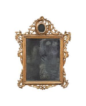 Carved and gilded wooden mirror. Venice, 18th century.