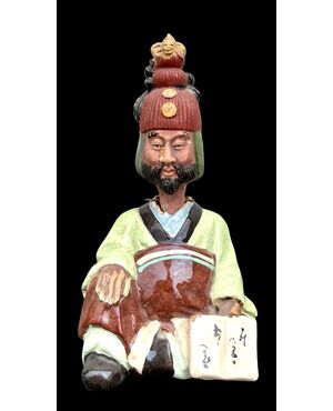 Ceramic figure depicting a Japanese character. Articulated head.
