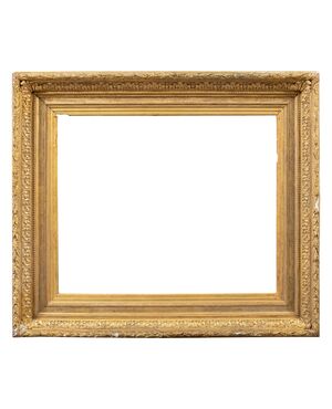 Carved and gilded wooden frame with pastiglia reliefs. Italy, late 19th century.