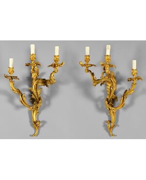 Pair of French gilded bronze three-light sconces, Louis XV style, 19th century