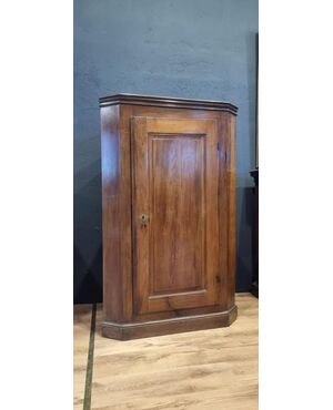 Early 19th-century Empire-style corner cabinet in solid walnut.