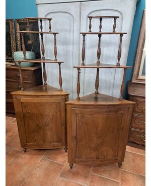 Pair of serpentine corner cabinets in blond walnut