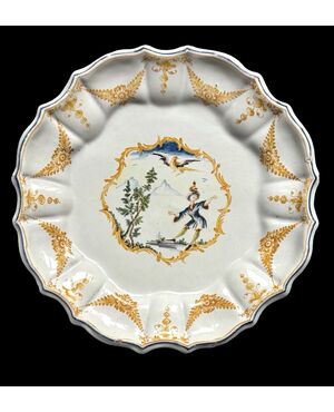 Piatto in maiolica decorato con personaggio in ambiente agreste.Manifattura Coppellotti.Lodi.