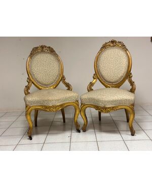 Pair of carved and gilded wooden armchairs. 19th century