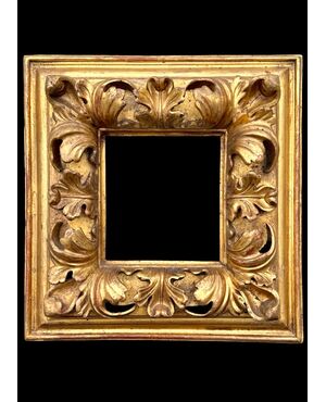 Carved and gilded wooden frame.