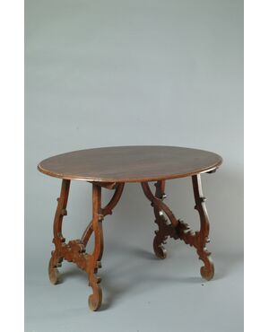 Marche, late 17th century, lyre-shaped center table in carved wood     