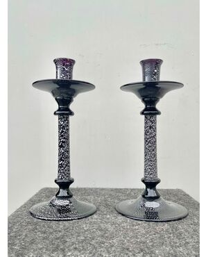 Pair of dark amethyst glass candlesticks with inclusion of silver leaf.Murano.     