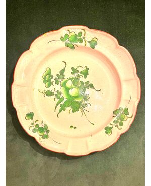 Majolica plate with green decoration with floral motifs.Strasbourg. France     