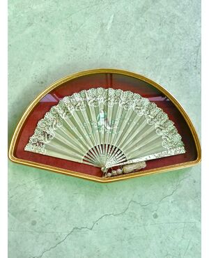 Fan framed with mother-of-pearl and wood ribs, bunting in silk and lace, painted with a girl.     