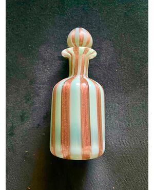 Perfume bottle in glass with milky green and aventurine vertical bands.Cenedese manufacture, Murano.     