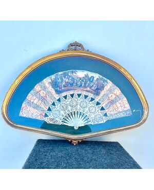Fan framed with bunting painted with popular scene and ribs in pierced ivory.     