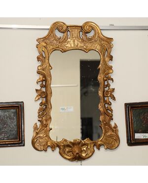 Shaped and carved gilded wooden mirror     