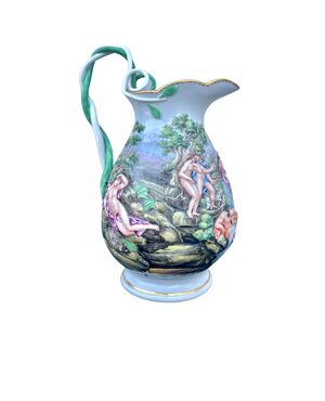 Porcelain milk jug with polychrome bas-relief decoration and interwoven vegetable motif grip.Manufactured by Doccia Ginori.     