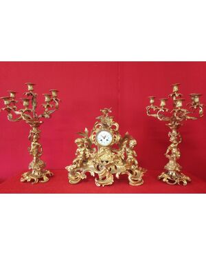 Clock and pair of candelabra in gilded bronze