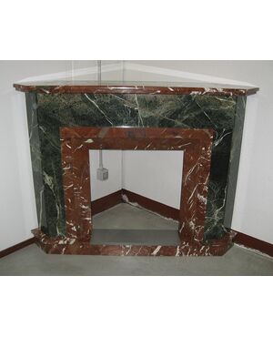 Antique corner fireplace in two-tone marble. Early 1900s