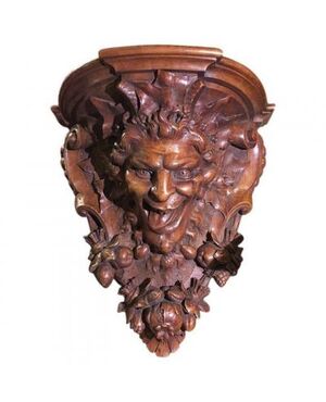 Carved walnut shelf depicting a satyr&#39;s head     