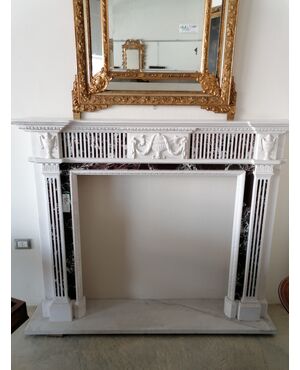 Fireplace in white and burgundy red marble with Louis XVI style decorations     