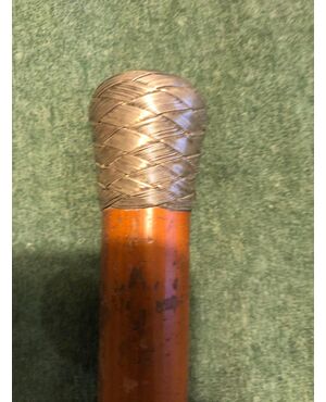 Stick with braided silver knob and rattan cane.     
