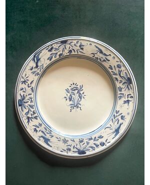 Majolica plate in turquoise monochrome with stylized birds and floral and plant motifs.     