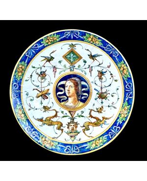 Majolica cutting board with Raphaelesque decoration and vegetable motifs and medallion with &#39;bella&#39;, Eleonora.Minghetti Manufacture, Bologna.     
