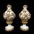 Coppia di grandi lampade in maiolica con parti in rilievo dorate a freddo con motivi a festoni,floreali e doppio medaglione.Toscana.