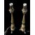 Coppia di candelieri in bronzo trasformati a lampade con tre piedi leonini e fusto con foglie stilizzate.
