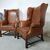 Coppia di poltrone bergere inglese originale in pelle marrone cognac 