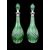 Coppie di bottiglie in cristallo verde molato con collo in argento.