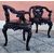 Quattro poltrone a 3 gambe orientali