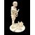 Scultura okimono in avorio raffigurante personaggio maschile con treccia e cesto.Giappone.