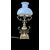 Lampada in ottone con corpo rastremato e bracci laterali rocaille.Cappello in vetro lattimo.