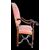 Poltrona in noce con braccioli a volute e gambe tornite.