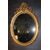 Specchiera ovale orizzontale francese del 1800 stile Luigi XV dorata foglia oro