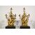  Coppia di grandi candelabri a tre luci in bronzo dorato con aironi e fiori in porcellana policroma, Francia, XIX secolo