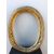 Oval frame in carved wood with leaf and gold leaf motif.     