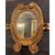 SPECC558 - Oval lacquered and gilded mirror, '7/'800 period, measures cm W 105 x H 207