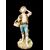 Polychrome majolica sculpture depicting a peasant drinking eggs. Ginori.