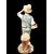 Polychrome majolica sculpture depicting a peasant drinking eggs. Ginori.