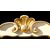 Testiera letto in legno scolpito con motivi rocaille color crema e oro.