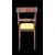 Four walnut chairs with geometric pattern decoration.