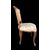 Four walnut chairs with floral pattern carvings.