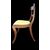 Four walnut chairs with geometric pattern decoration.